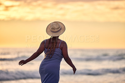Buy stock photo Back, sunset or black woman at beach walking to relax on holiday vacation for outdoor break in Greece. Tourist, girl or African person looking at ocean, nature or sea with peace, wellness or travel