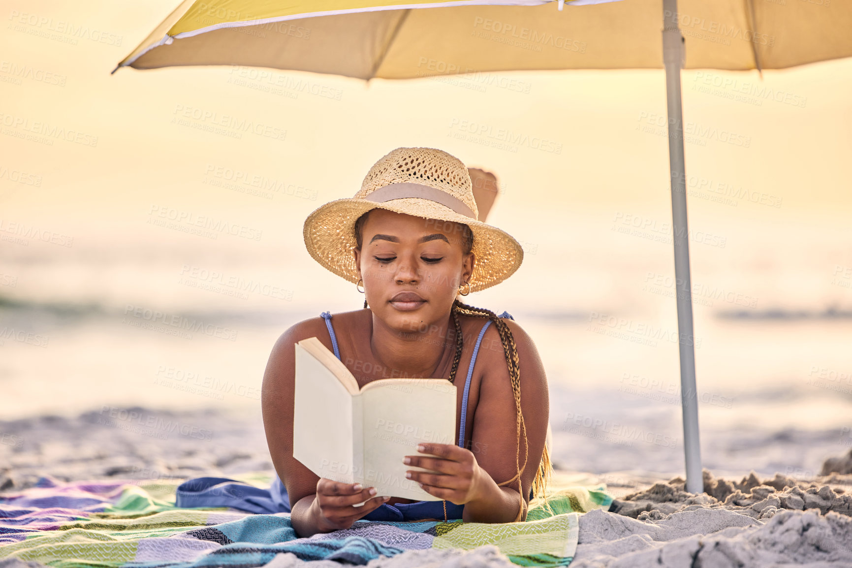 Buy stock photo Sunset, relax or black woman reading book at ocean for alone time, rest break or holiday vacation. Beach, travel or African person with fiction story or novel for knowledge, peace or hobby in Greece