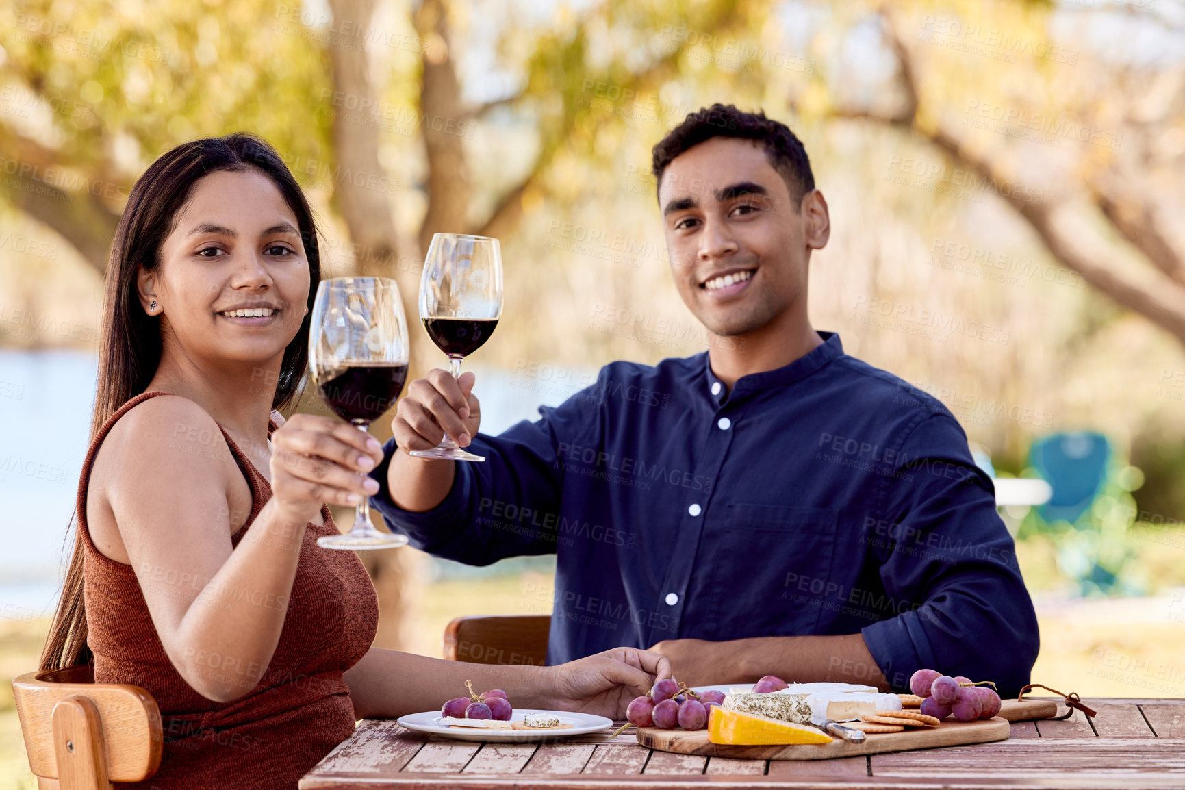 Buy stock photo Couple, wine and farm with food at table for relationship, toast for anniversary with cheese board. Man, woman and restaurant with alcohol for cheers on date, celebrate at vineyard with food or drink