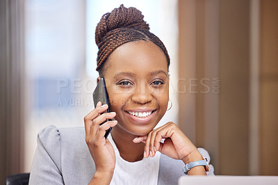 Buy stock photo Cropped portrait of an attractive young businesswoman making a phonecall while working on her laptop in the office