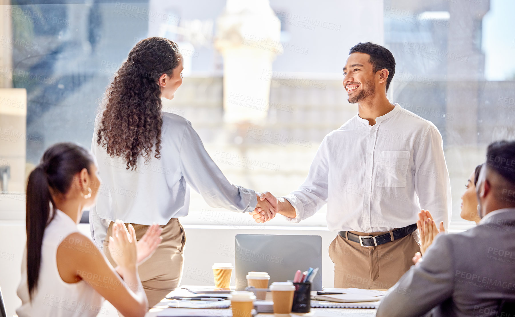 Buy stock photo Shot of two businesspeople shaking hands during a meeting in an office