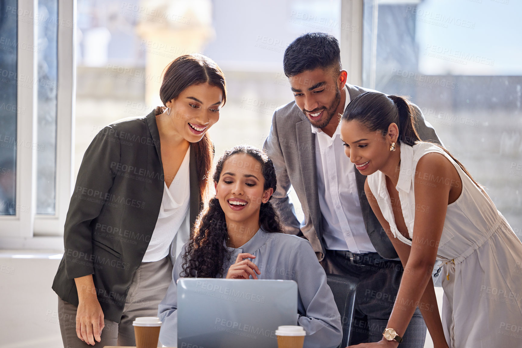 Buy stock photo Shot of a group of businesspeople working together on a laptop in an office