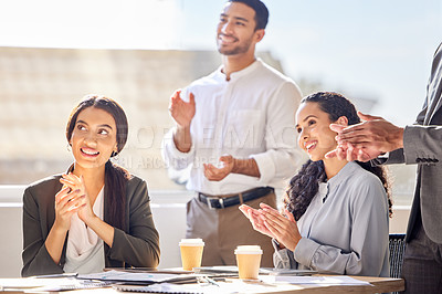 Buy stock photo Shot of a group of businesspeople applauding during a meeting in an office