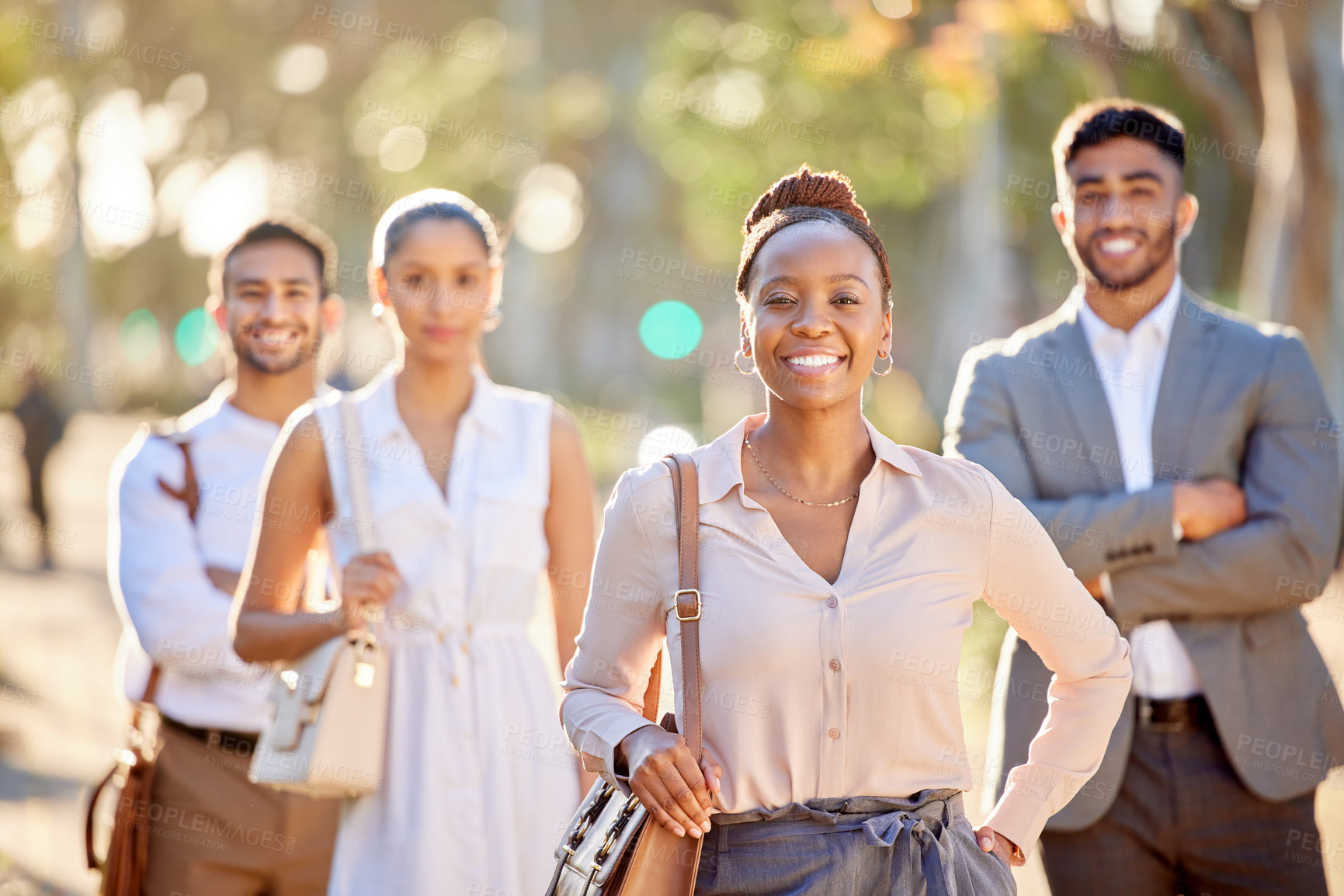 Buy stock photo Shot of a diverse group of businesspeople standing together in the city after a day in the office