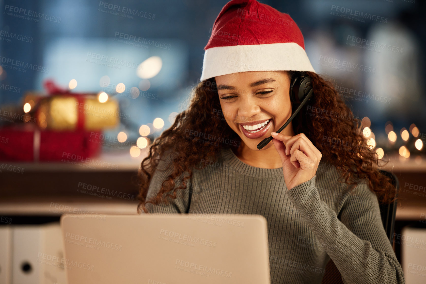 Buy stock photo Christmas hat, call center and female agent working overtime in office at night in festive. Laptop, contact us and woman customer support consultant with online crm consultation with headset on xmas.