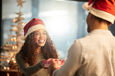 Buy stock photo Shot of two young businesspeople celebrating Christmas at work