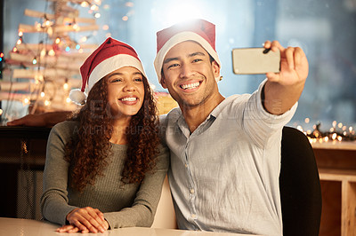 Buy stock photo Couple, phone and selfie for Christmas, celebration and party or work event in office together. Man, woman and smartphone for social media, happiness and memory at night while on vacation or holiday