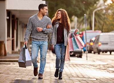 Buy stock photo Full length shot of an affectionate young couple enjoying a shopping spree in the city