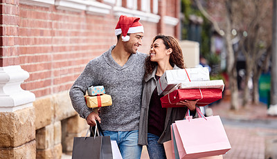 Buy stock photo Cropped shot of an affectionate young couple enjoying a shopping spree in the city