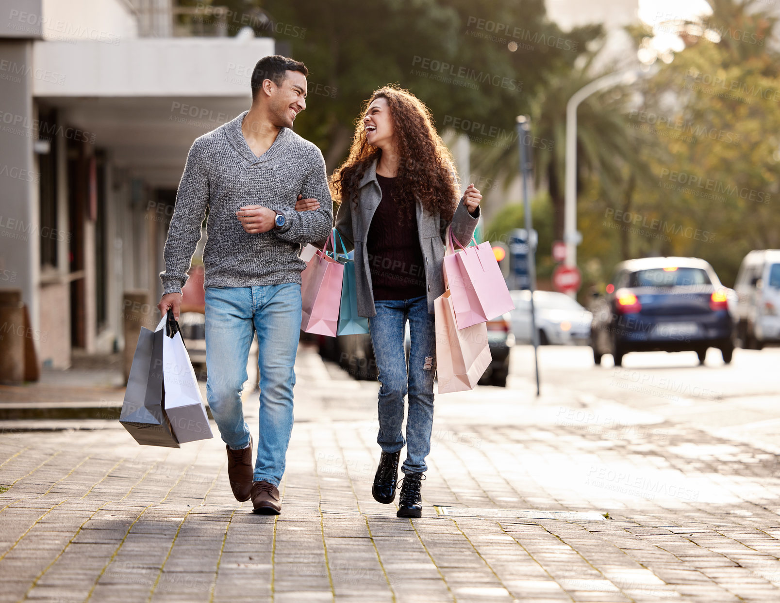 Buy stock photo Happy couple, shopping bags and walking in city together for fashion, gift or buying in the outdoors. Man and woman in relationship with smile for customer discount, purchase or payment in urban town