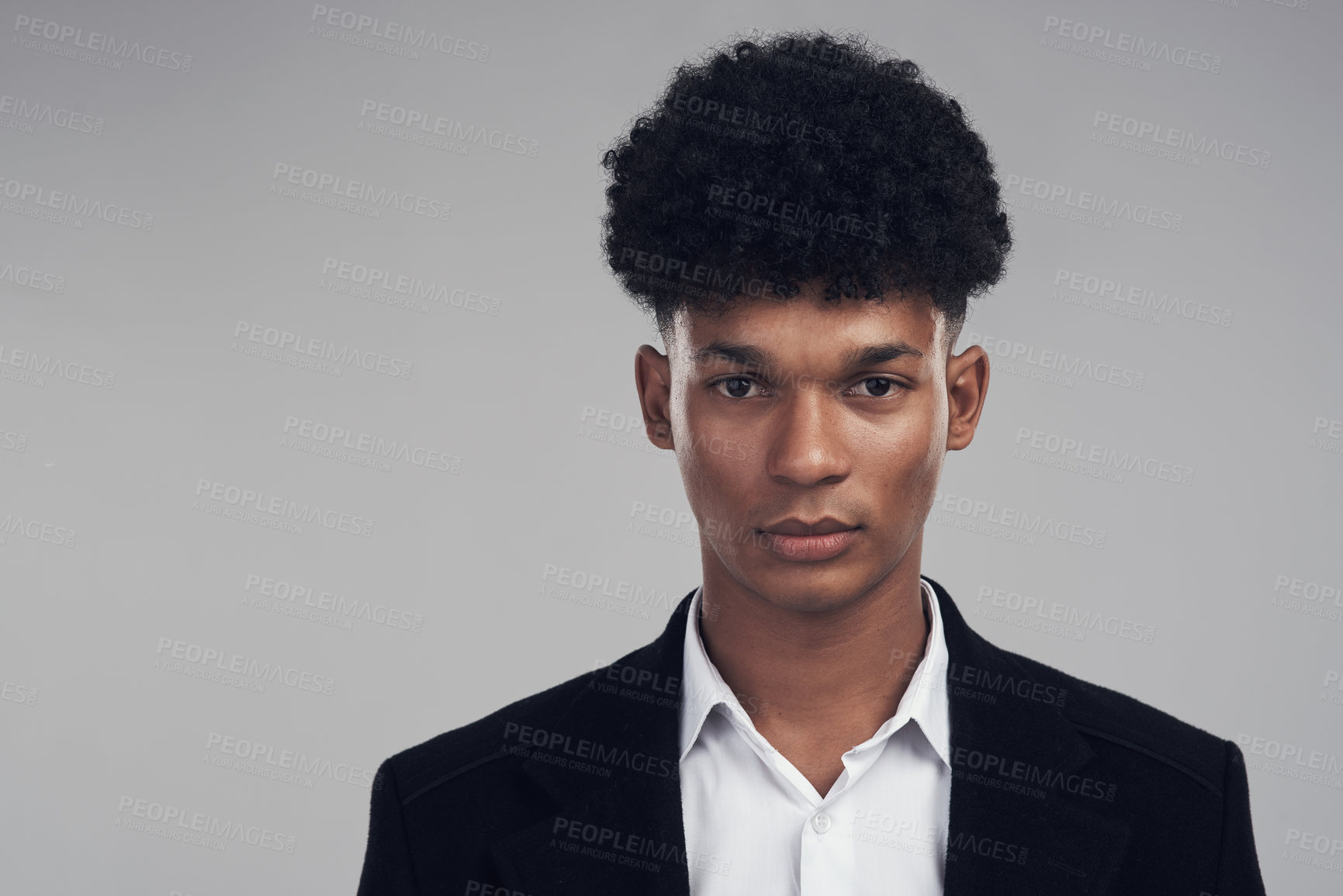 Buy stock photo Studio portrait of a confident young businessman posing against a grey background