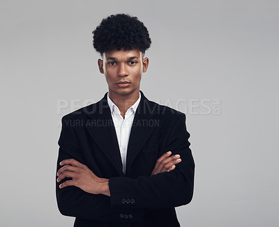 Buy stock photo Studio portrait of a confident young businessman posing against a grey background