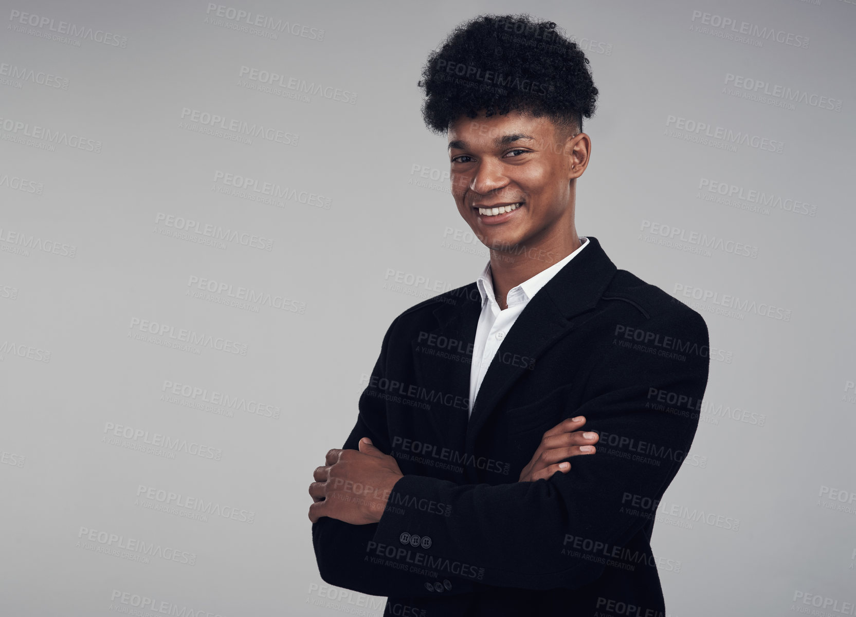 Buy stock photo Studio portrait of a confident young businessman posing against a grey background