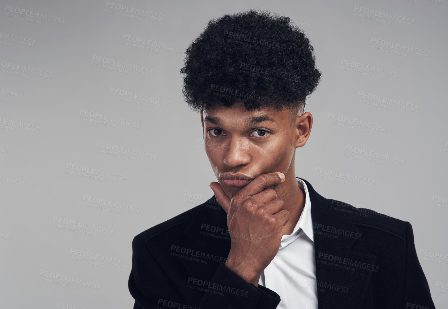 Buy stock photo Studio portrait of a confident young businessman posing against a grey background