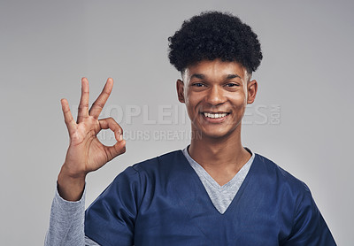 Buy stock photo Shot of a male nurse showing the ok sign while standing against a grey background