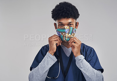 Buy stock photo Shot of a male nurse wearing a mask while standing against a grey background