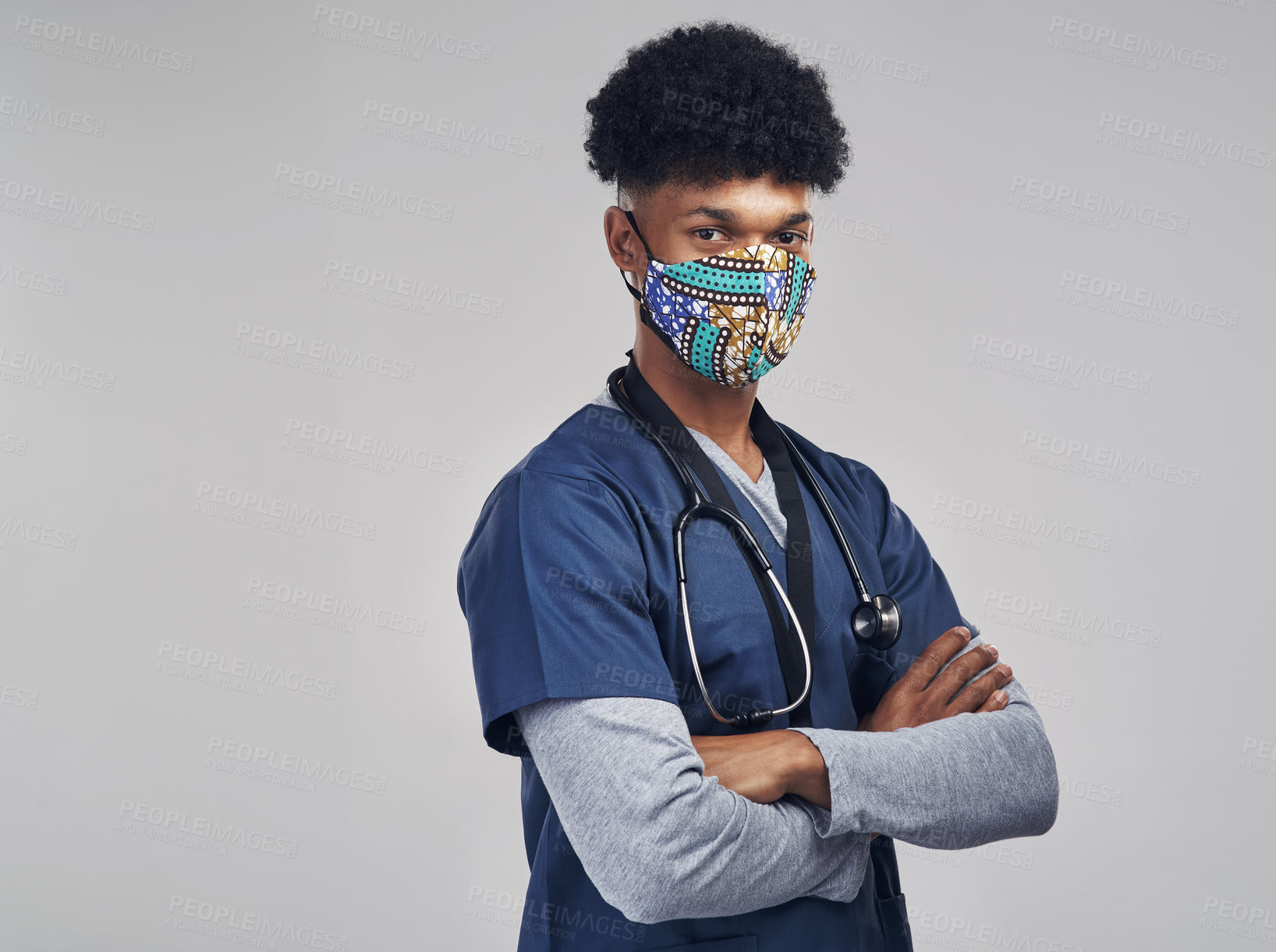 Buy stock photo Shot of a male nurse wearing a mask while standing against a grey background