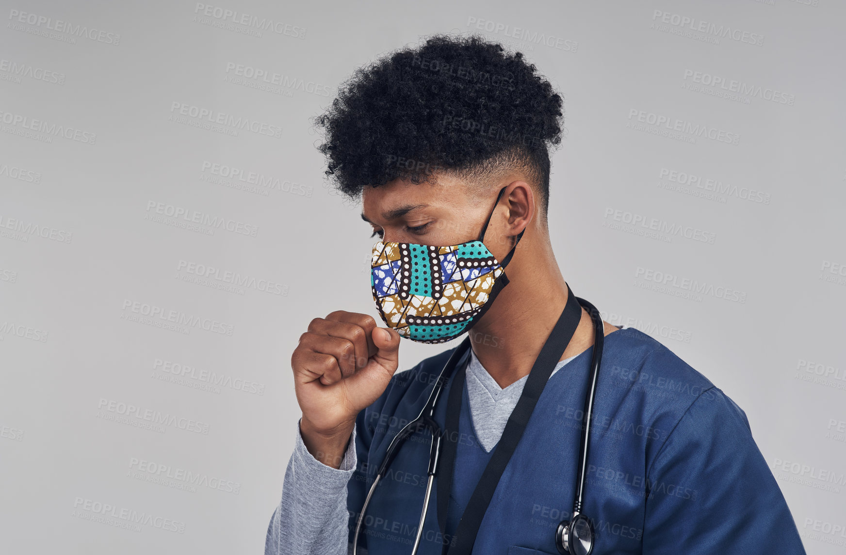 Buy stock photo Shot of a male nurse coughing while wearing a face mask