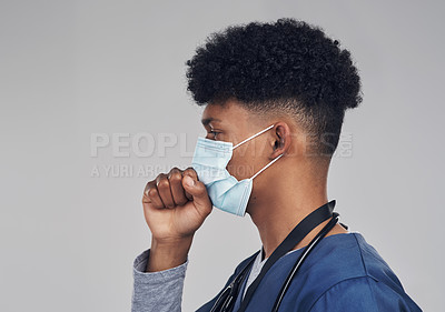 Buy stock photo Shot of a male nurse coughing while wearing a face mask