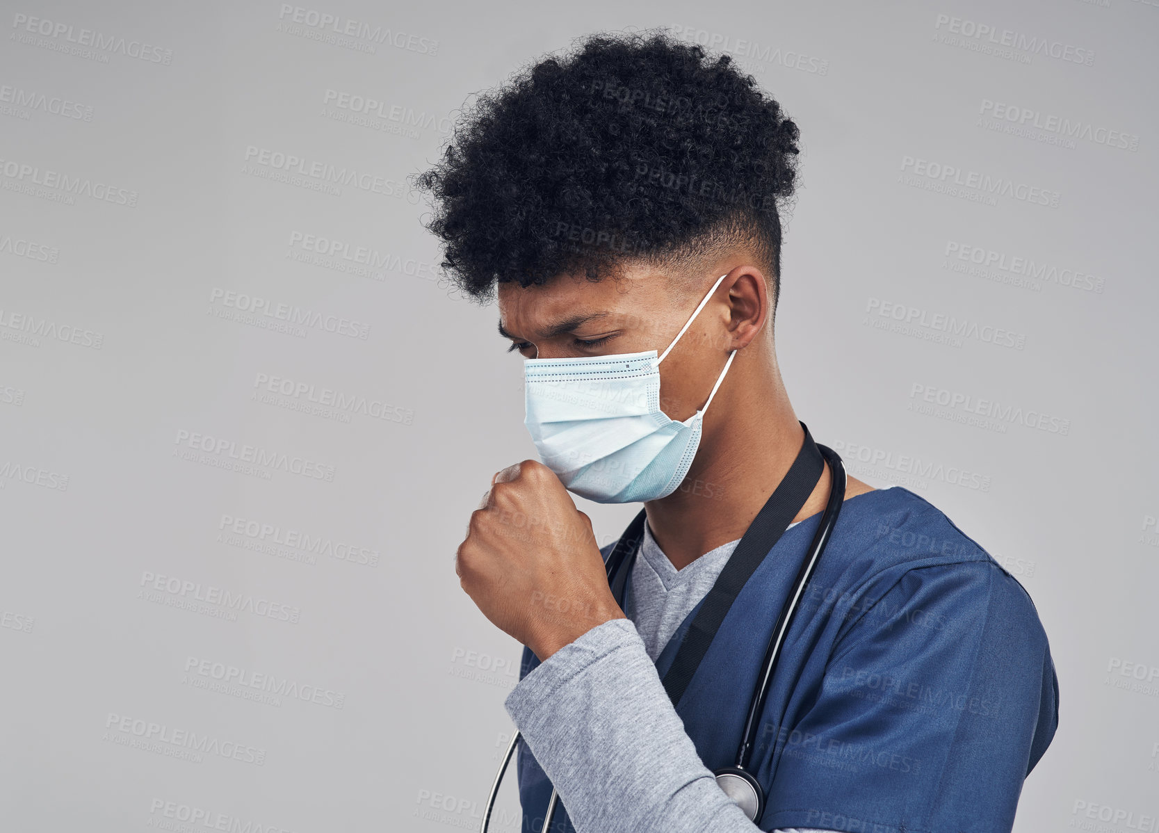 Buy stock photo Shot of a male nurse coughing while wearing a face mask