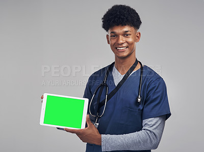 Buy stock photo Shot of a male nurse holding up a digital tablet