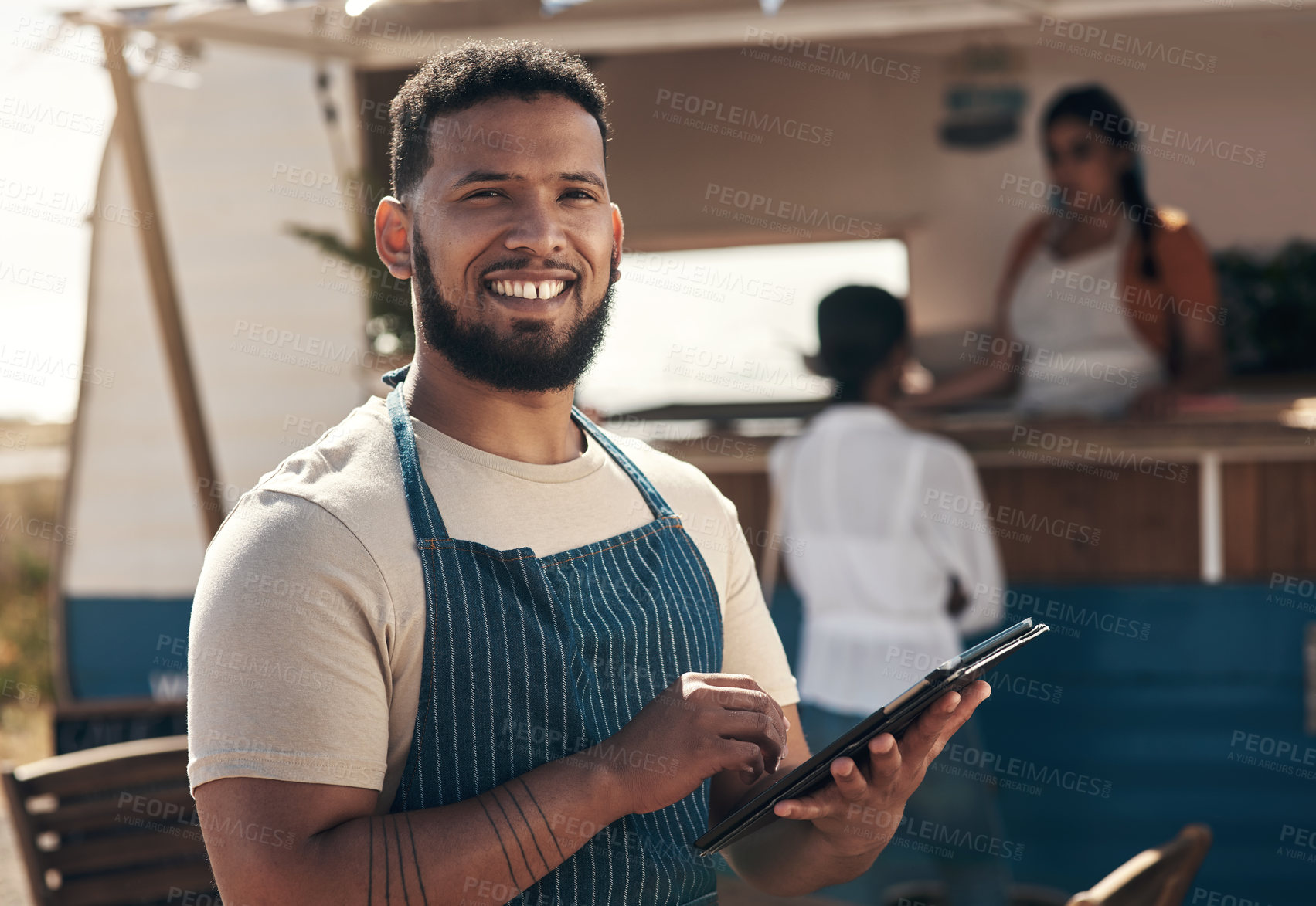 Buy stock photo Shot of a young business owner using his digital tablet