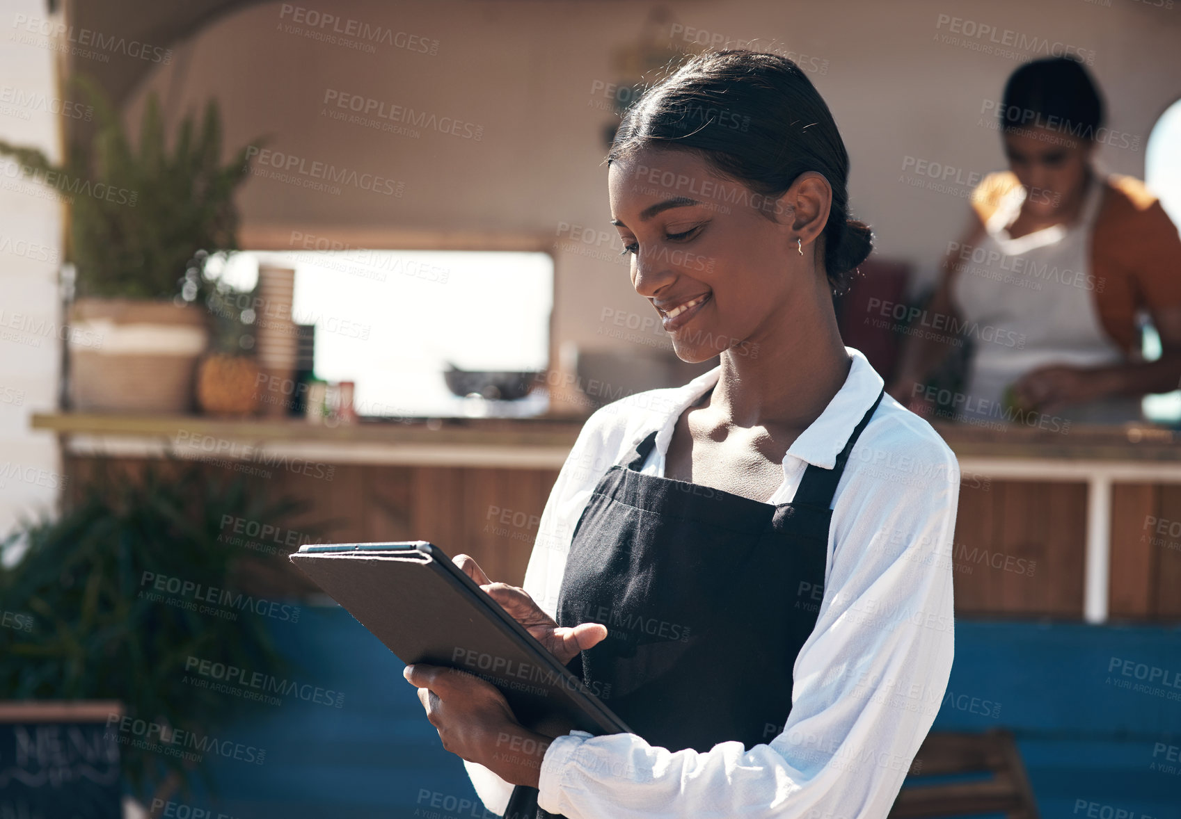 Buy stock photo Shot of a businesswoman using her digital tablet at work