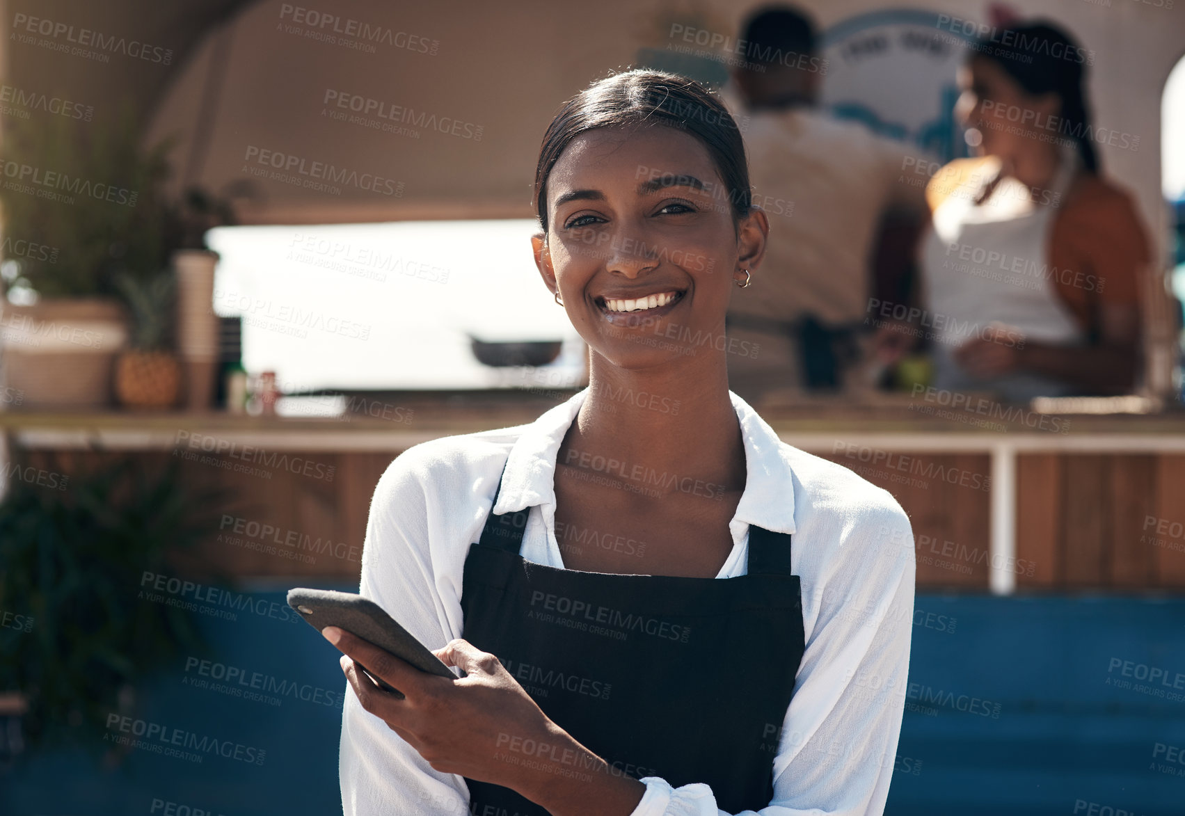 Buy stock photo Shot of a business owner using her smartphone to send a text