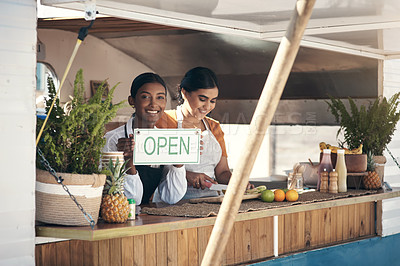 Buy stock photo Shot of a businesswoman holding an open sign for her food truck