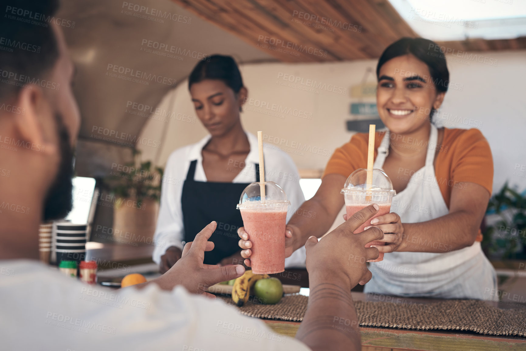 Buy stock photo Shot of a businesswoman giving her customer his smoothie