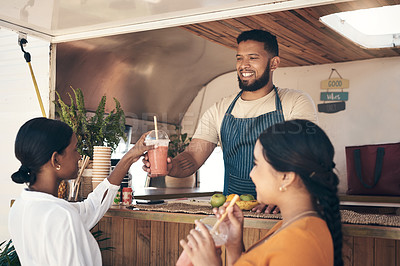 Buy stock photo Shot of two friends enjoying smoothies together