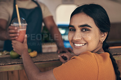 Buy stock photo Shot of a woman buying and drinking a smoothie from a food truck