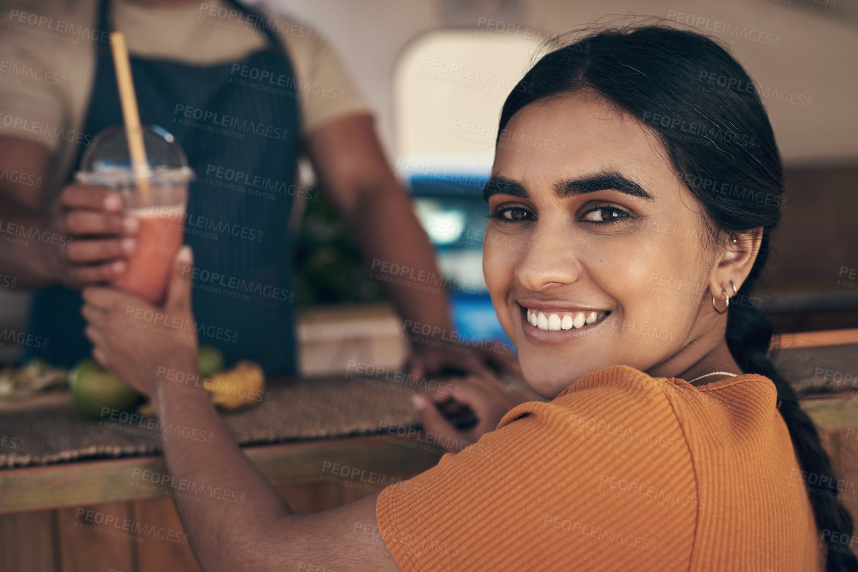 Buy stock photo Shot of a woman buying and drinking a smoothie from a food truck