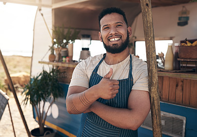 Buy stock photo Shot of a young businessman standing outside of his food truck
