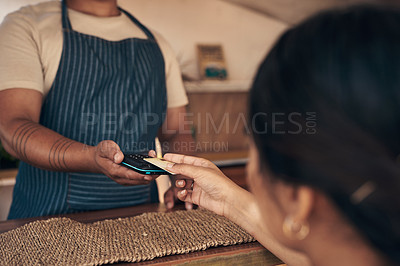 Buy stock photo Shot of a customer paying for their smoothie