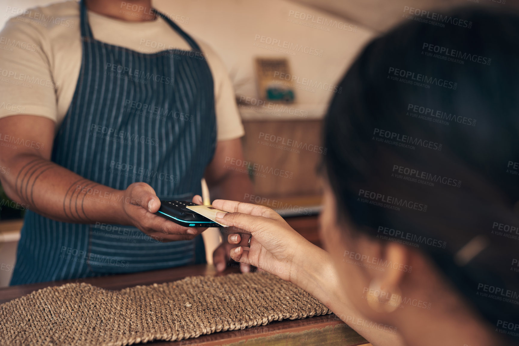 Buy stock photo Shot of a customer paying for their smoothie