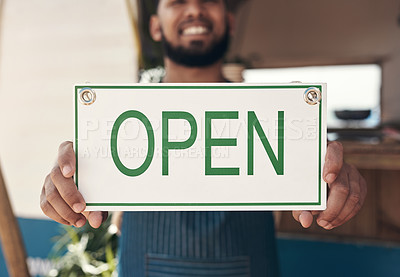 Buy stock photo Shot of a businessman holding an open business sign