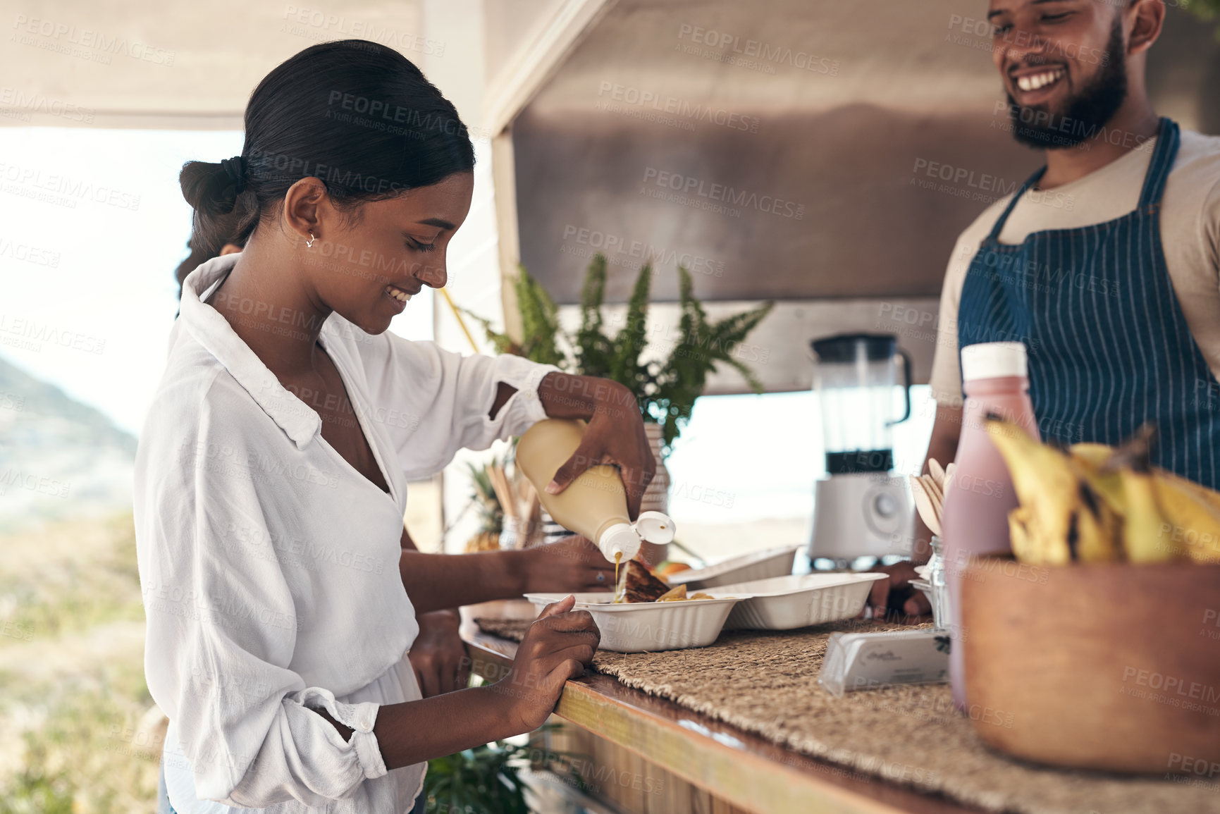 Buy stock photo Shot of a woman putting mustard on her food