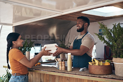 Buy stock photo Shot of a customer receiving their food order