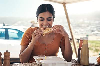 Buy stock photo Shot of a young woman enjoying some food