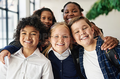 Buy stock photo Shot of a diverse group of children standing together in the hallway at school during the day