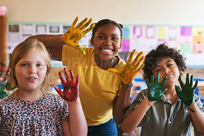 Buy stock photo Shot of a diverse group of children standing together in their classroom at school with their hands painted