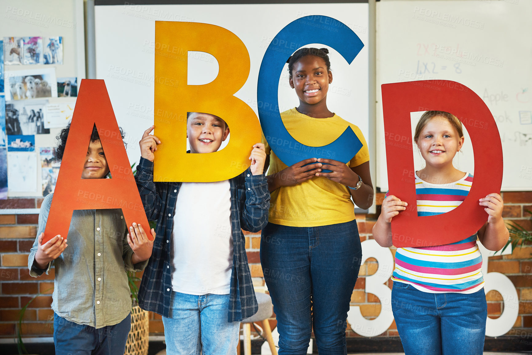 Buy stock photo Children, sign and letters of alphabet in classroom with smile, portrait and diversity for education. School kids, group and happy with friends, board and solidarity for learning with text at academy