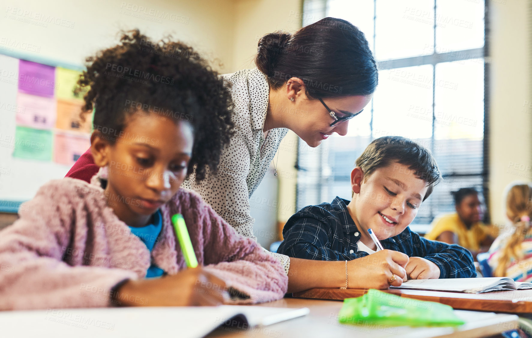 Buy stock photo Learning, teacher and help kid in classroom for education support, development or scholarship. Workbook, educator or student at elementary school for lesson assistance, knowledge or academic feedback