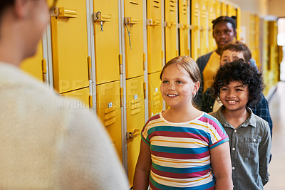 Buy stock photo Shot of a diverse group of children lining up outside their classroom at school to greet their teacher