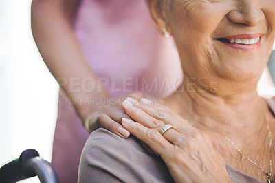 Buy stock photo Cropped shot of a nurse caring for an older woman in a wheelchair