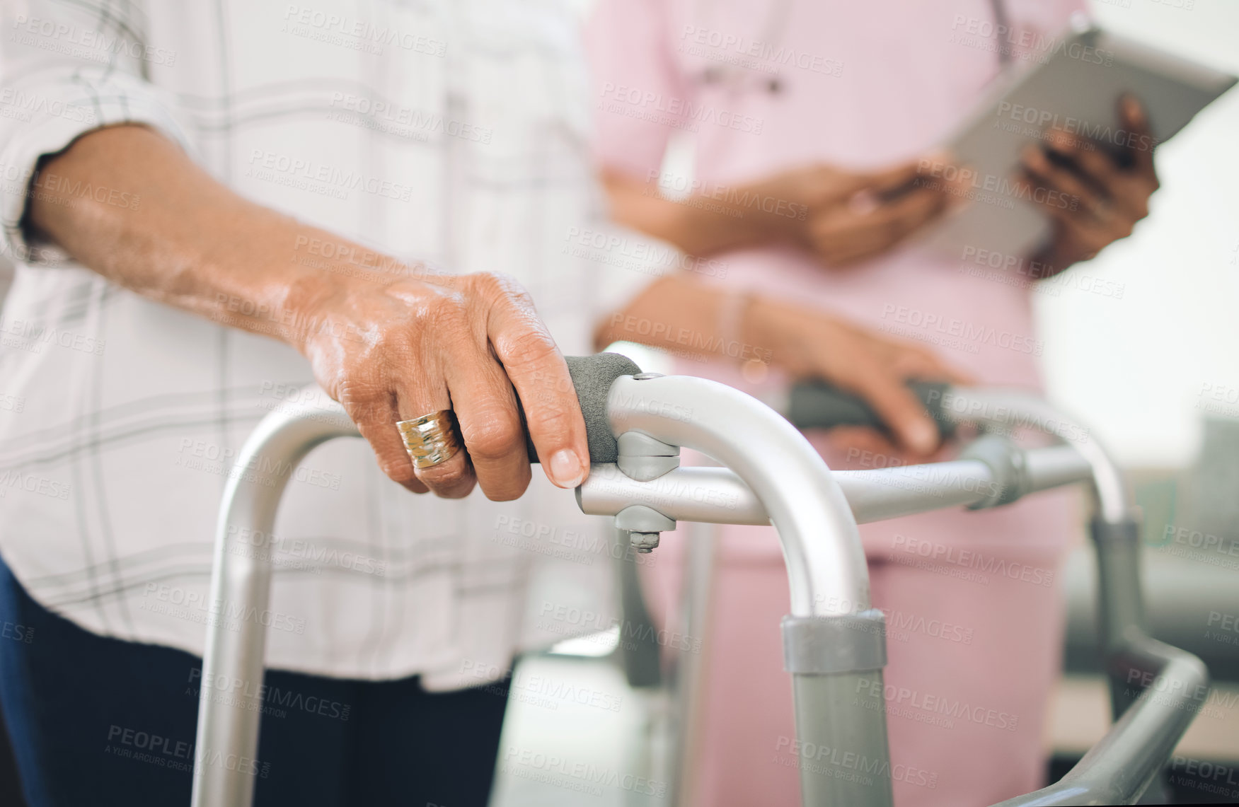 Buy stock photo Hands, walker and nurse on tablet for assisted living, guide steps and balance in at retirement home. Elderly person with disability, caregiver and tech with walking frame, support and app at house