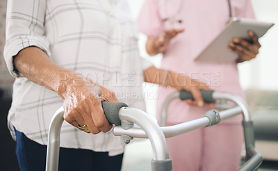 Buy stock photo Cropped shot of an unrecognizable older woman using a walker and walking with the assistance of a physiotherapist