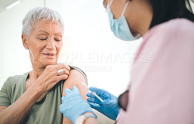 Buy stock photo Shot of a doctor giving an older woman an injection at home