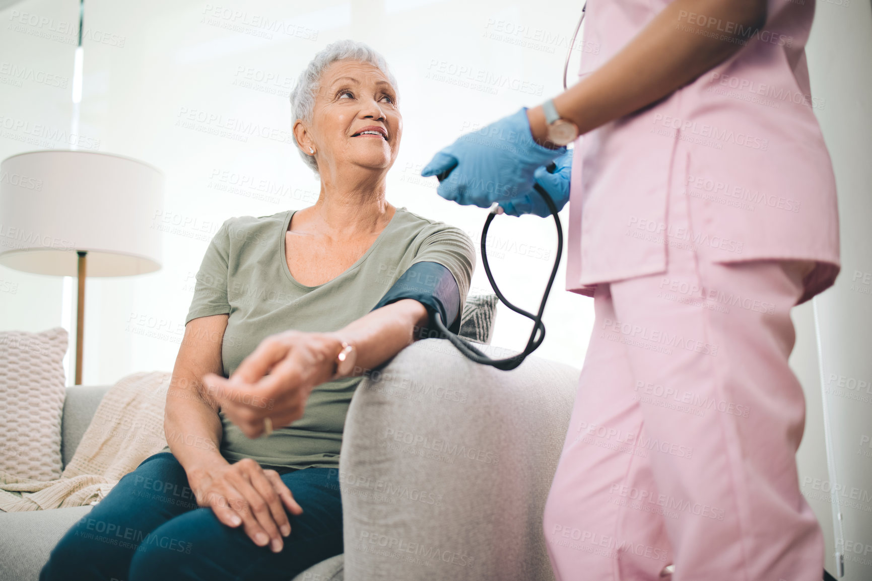 Buy stock photo Blood pressure, nurse and senior woman in lounge, test and wellness support for checkup. Pensioner, caregiver and old person in home, healthcare stats or medical service in retirement or conversation